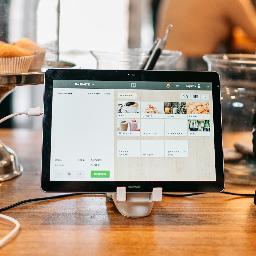 silver ipad on brown wooden table